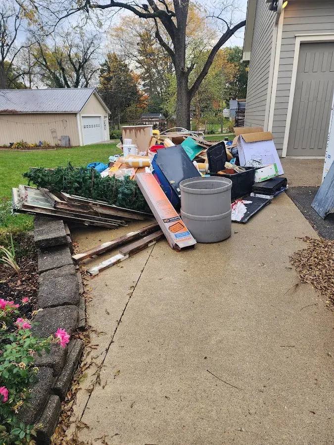 Dumpster being loaded with debris for Estate Cleanout Dumpster Rental in Midland